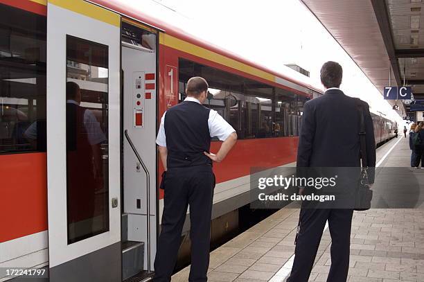 conductor and porter on european train - train guard stock pictures, royalty-free photos & images