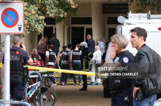 French police officers from the forensic service stand in front of the Gambetta high school in Arras, northeastern France on October 13 after a...