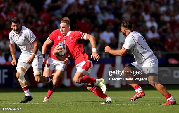 Liam Williams of Wales runs with the ball whilst under pressure from Guram Gogichashvili of Georgia during the Rugby World Cup France 2023 match...