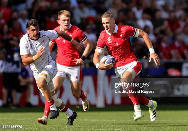 Liam Williams of Wales runs with the ball whilst under pressure from Mikheil Gachechiladze of Georgia during the Rugby World Cup France 2023 match...