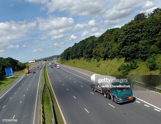 overview of chemical tanker speeding down the highway - bord gevaar stockfoto's en -beelden