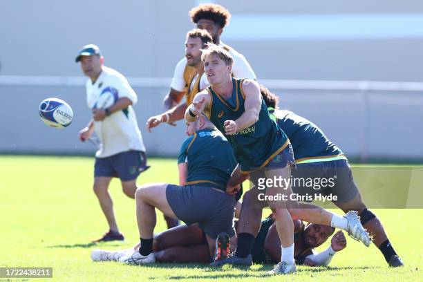 Tate McDermott passes during a Wallabies training session, at Stade Roger Baudras on October 07, 2023 in Saint-Etienne, France.