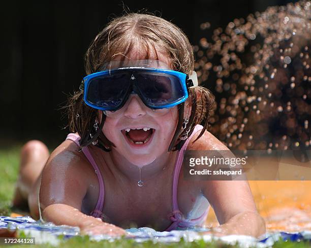 slip-n-sliding - backyard water slide stock pictures, royalty-free photos & images
