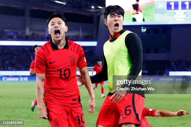 Cho Youngwook of South Korea celebrates his goal with teammates during the 19th Asian Game men's gold medal match between South Korea and Japan at...