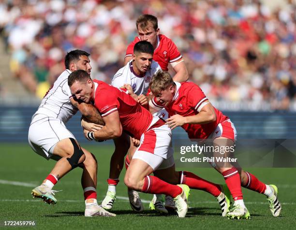 George North of Wales is tackled by Giorgi Kveseladze and Davit Niniashvili of Georgia during the Rugby World Cup France 2023 match between Wales and...