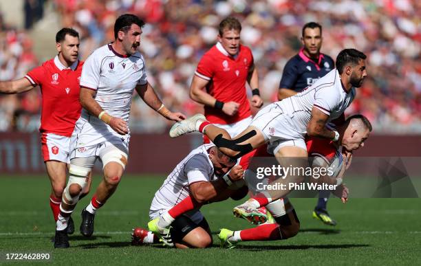 Liam Williams of Wales is tackled by Giorgi Kveseladze and Guram Gogichashvili of Georgia during the Rugby World Cup France 2023 match between Wales...
