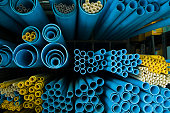 End-view of groups of different sized blue and yellow tubes