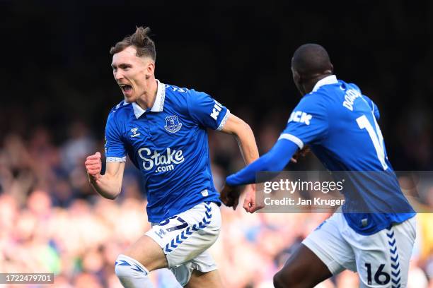 James Garner of Everton celebrates with teammate Abdoulaye Doucoure after scoring the team's first goal during the Premier League match between...