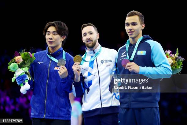 Silver medalist Kazuki Minami of Team Japan, gold medalist Artem Dolgopyat of Team Israel and bronze medalist Milad Karimi of Team Kazakhstan pose...