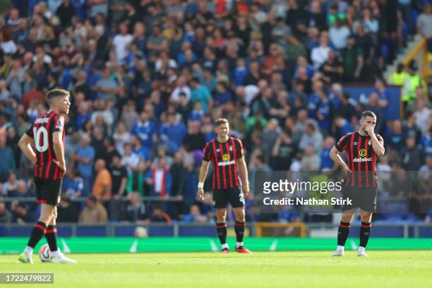 Lewis Cook of AFC Bournemouth and teammates look dejected after James Garner of Everton scores the team's first goal during the Premier League match...