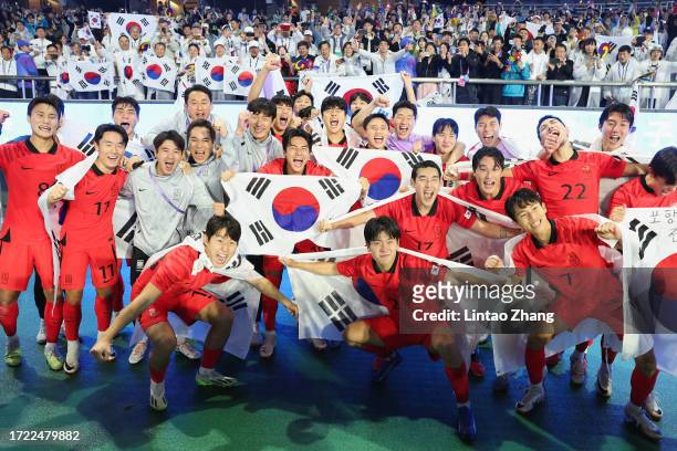 Team of South Korea celebrates after winning the gold medallists during the 19th Asian Game men's gold medal match between South Korea and Japan at...