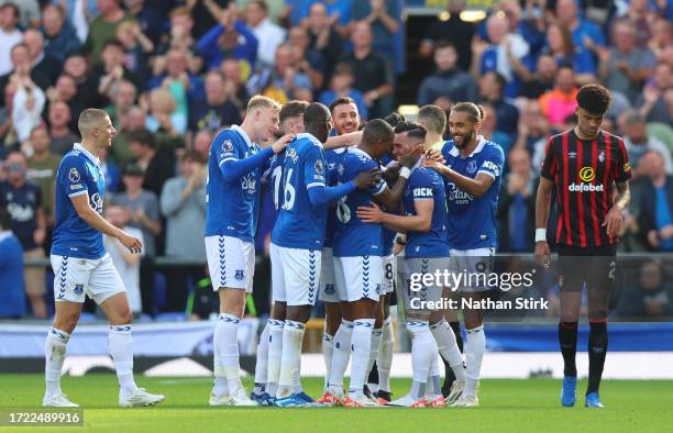 Jack Harrison of Everton celebrates with teammates after scoring the team's second goal as Ryan Fredericks of AFC Bournemouth looks dejected during...