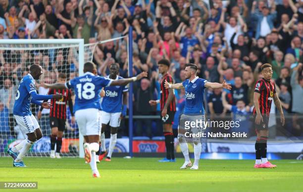 Jack Harrison of Everton celebrates with teammates after scoring the team's second goal as Ryan Fredericks of AFC Bournemouth looks dejected during...