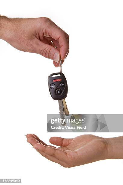 one hand dropping the car keys into another - bob stockfoto's en -beelden