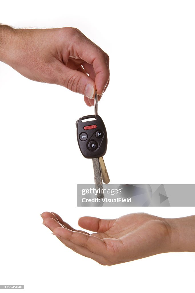 One hand dropping the car keys into another