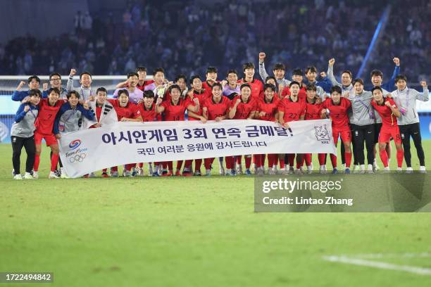 Team of South Korea celebrates after winning the gold medallists during the 19th Asian Game men's gold medal match between South Korea and Japan at...