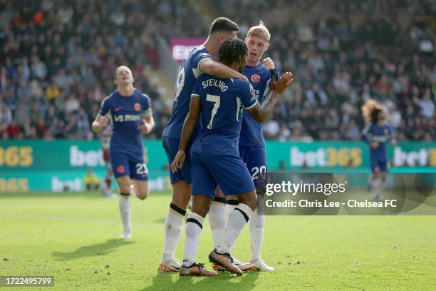 Raheem Sterling, Armando Broja and Cole Palmer of Chelsea celebrate after Ameen Al-Dakhil of Burnley scores their sides own goal during the Premier...