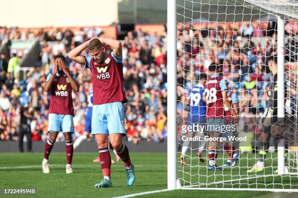 Charlie Taylor of Burnley reacts after Ameen Al-Dakhil of Burnley scores their sides own goal during the Premier League match between Burnley FC and...