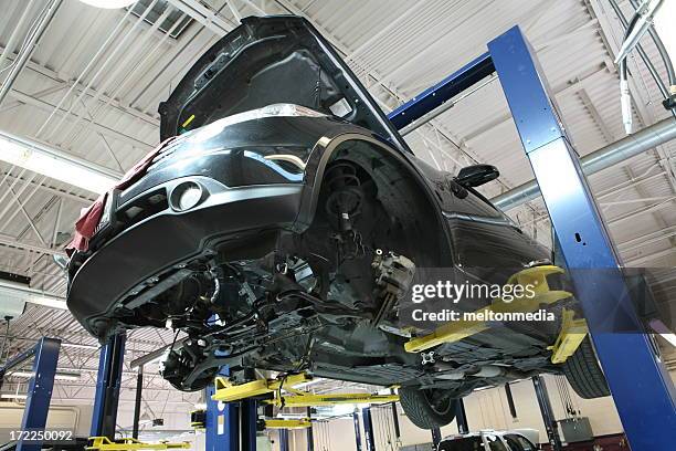 underside view of a car in an auto repair shop - car underside stock pictures, royalty-free photos & images