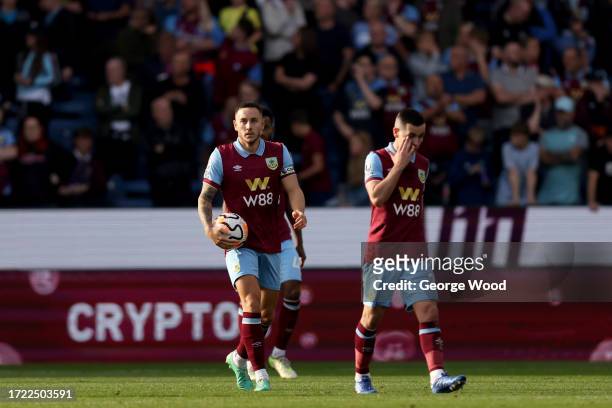 Josh Brownhill and Josh Cullen of Burnley react after Cole Palmer of Chelsea scores their sides second goal during the Premier League match between...
