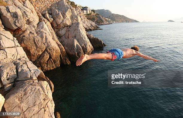 cliff diver - cliff diving stock pictures, royalty-free photos & images