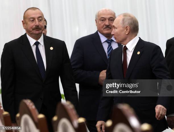 Azerbaijan's President Ilham Aliyev, Belarussian President Alexander Lukashenko and Russian President Vladimir Putin enter the hall during the...