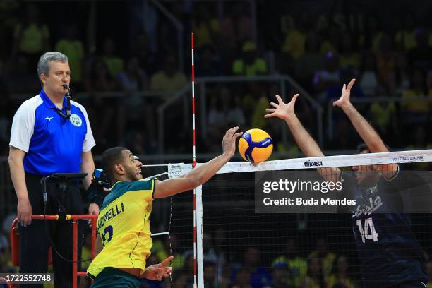 Lucarelli of Brazil jumps to spike the ball against Javad Karimisouchelmaei of Iran during the men's Olympic qualifying tournament 2023 volleyball...