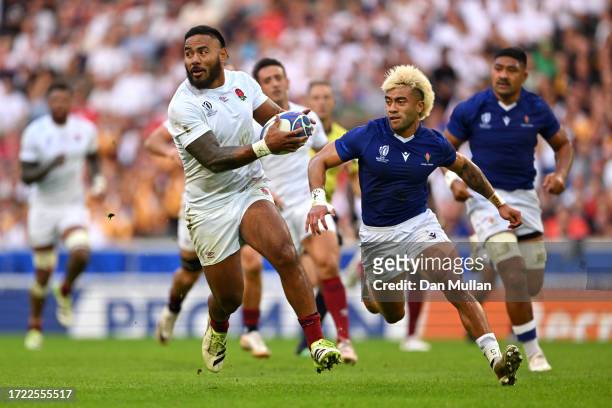 Manu Tuilagi of England breaks with the ball whilst under pressure from Jonathan Taumateine of Samoa during the Rugby World Cup France 2023 match...