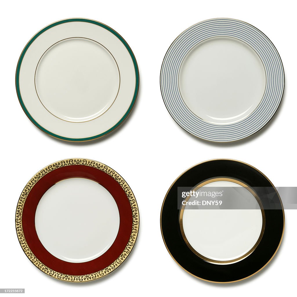 Four dinner plates on white background