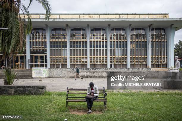 Student checks his phone in front of the John F.Kennedy Memorial Library inside Addis Ababa University, Ethiopia on October 13, 2023.