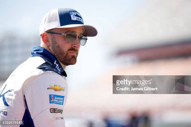 Austin Dillon, driver of the Huk Performance Fishing Chevrolet, looks on during practice for the NASCAR Cup Series Bank of America ROVAL 400 at...