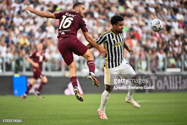 Nikola Vlasic of Torino FC against Weston McKennie of Juventus FC during the Serie A TIM match between Juventus and Torino FC at on October 7, 2023...