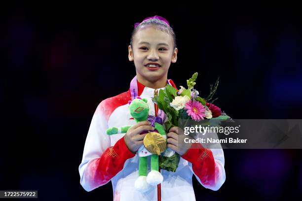 Gold medalist Qiyuan Qiu of Team People's Republic of China poses for a photo during the medal ceremony for the Women's Uneven Bars Final on Day...