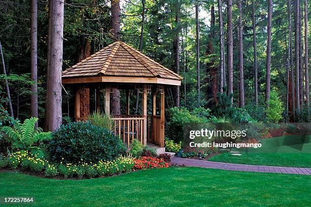 a beautiful backyard garden with a cedar wood gazebo - gazebo stock pictures, royalty-free photos & images