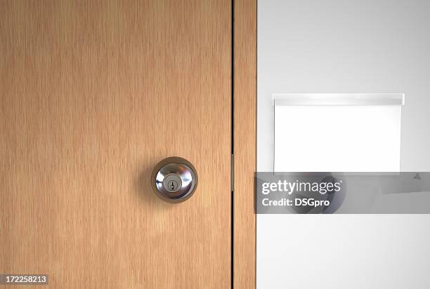 a blank name logo and a stainless door handle on wooden door - office signs stockfoto's en -beelden