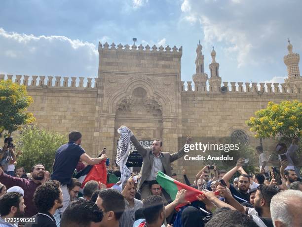 Muslims shout out slogans and raise Palestinian flag as they protest Israel's retaliation against Gaza after Hamas' attack on Israel at Al-Azhar...