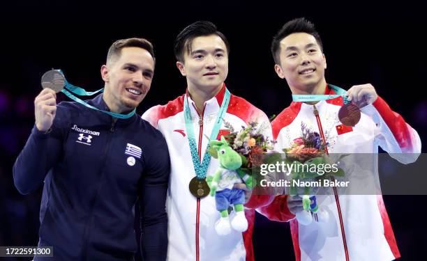 Silver medalist Eleftherios Petrounias of Team Greece, gold medalist Yang Liu of Team People's Republic and bronze medalist Hao You of Team People's...