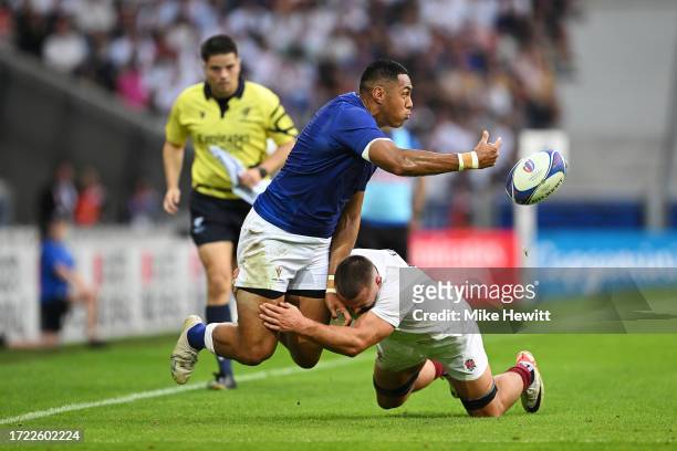 Nigel Ah-Wong of Samoa offloads the ball whilst being tackled by Ben Earl of England during the Rugby World Cup France 2023 match between England and...