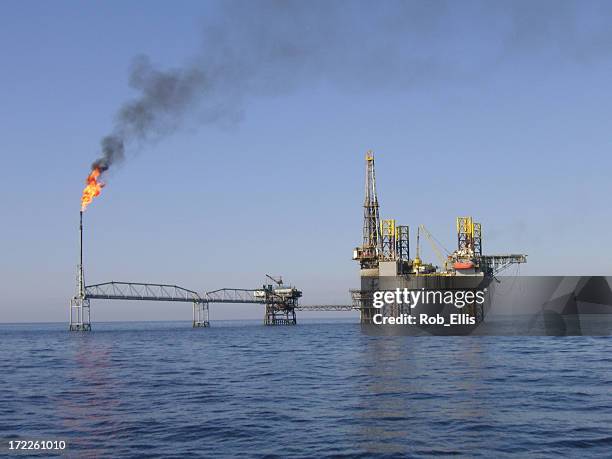 jackup over a producing platform - crude oil stock pictures, royalty-free photos & images