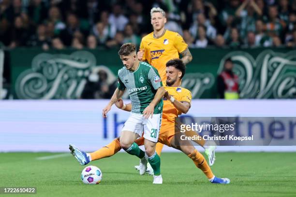 Romano Schmid of Werder Bremen is challenged by Florian Grillitsch of TSG 1899 Hoffenheim during the Bundesliga match between SV Werder Bremen and...