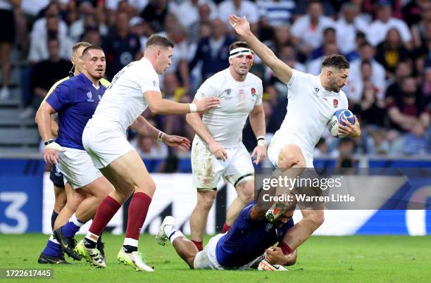 Jonny May of England is tackled by Theo McFarland of Samoa during the Rugby World Cup France 2023 match between England and Samoa at Stade Pierre...