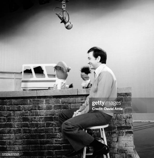 Actor and singer Bob McGrath rehearses with 'Anything Muppets' postman and dentist during Sesame Street's very first season, taken for America...