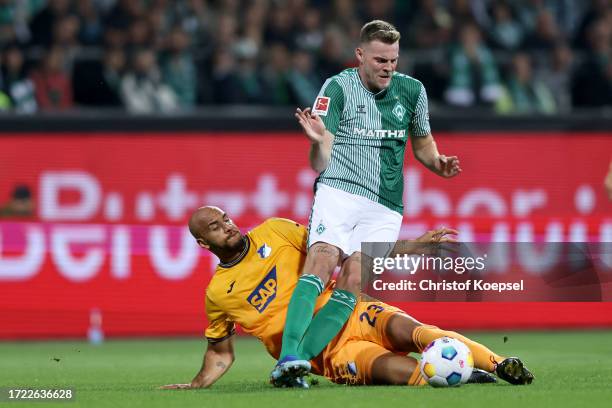 John Brooks of TSG 1899 Hoffenheim challenges Marvin Ducksch of Werder Bremen during the Bundesliga match between SV Werder Bremen and TSG Hoffenheim...