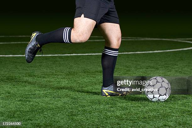 soccer player kicking ball - indoor soccer stock pictures, royalty-free photos & images