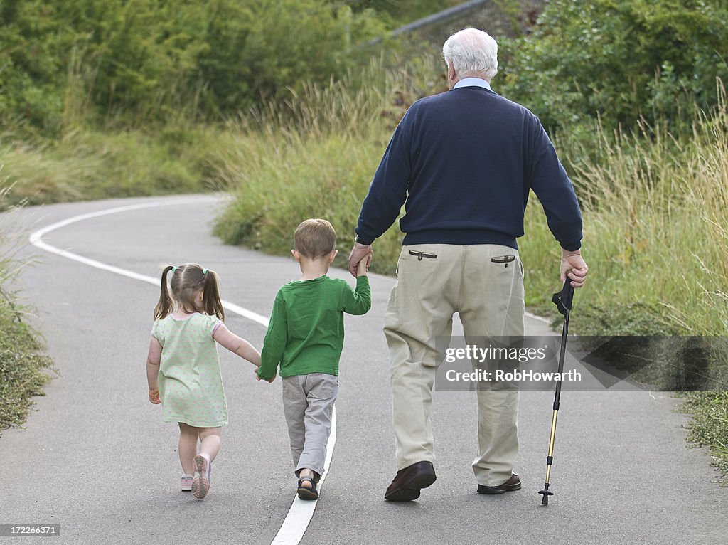 Grandfather going on a walk with his grandchildren