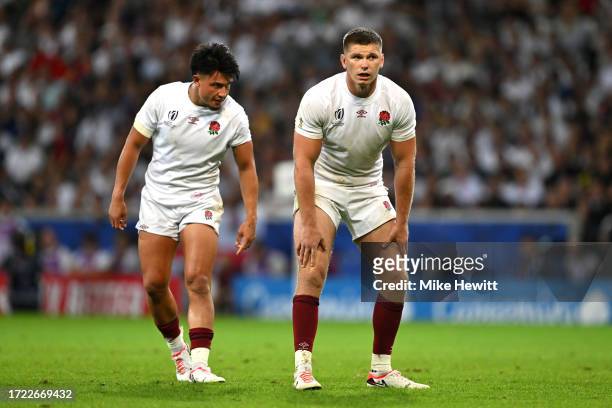 Marcus Smith and Owen Farrell of England look on as players of engage in a scrum during the Rugby World Cup France 2023 match between England and...