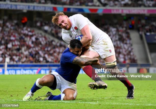 Ollie Chessum of England is challenged by Lima Sopoaga of Samoa during the Rugby World Cup France 2023 match between England and Samoa at Stade...