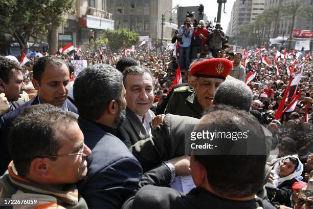 New Egyptian Prime Minister Essam Sharaf is greeted by thousands of demonstrators in Cairo's Tahrir Square during an uprising to demand political and...