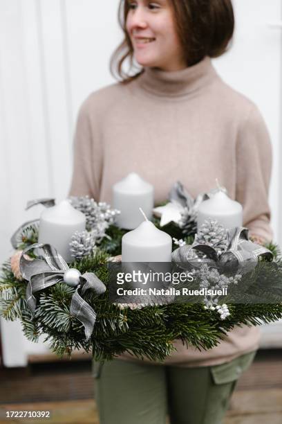 young girl 14-16 years old holding handmade advent wreath with four candles and smiling. - celebrating 15 years stock pictures, royalty-free photos & images
