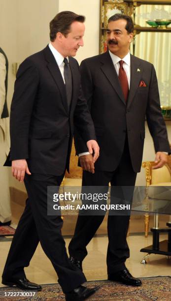 British Prime Minister David Cameron and his Pakistani counterpart Yousuf Raza Gilani chat prior to their meeting at the Prime Minister's House in...